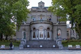 Canaux d'Ixelles avec bâtisse art déco et services de débouchage locaux, ciel bleu en arrière-plan